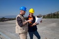 Young engineer girl and skilled worker on a roof Royalty Free Stock Photo