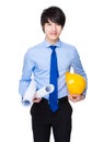 Young engineer hold with protective helmet and blue print Royalty Free Stock Photo