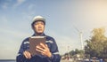 Young engineer man looking and checking wind turbines at field outdoor Royalty Free Stock Photo