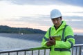 Young engineer man looking and checking wind turbines at field outdoor Royalty Free Stock Photo