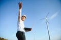 Young engineer man looking and checking wind turbines at field Royalty Free Stock Photo