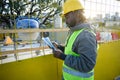 young engineer man at sunset at the construction site reading the tasks done during the working day Royalty Free Stock Photo