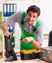 Young engineer repairing broken computer at the office Royalty Free Stock Photo