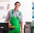 Young engineer repairing broken computer at the office Royalty Free Stock Photo