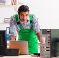 Young engineer repairing broken computer at the office Royalty Free Stock Photo