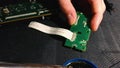 Young engineer soldering a board. Close up