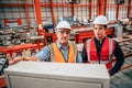 Young engineer standing with senior supervisor teamwork in metal factory happy worker team Royalty Free Stock Photo