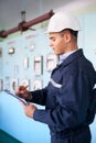 Young engineer taking notes at control room Royalty Free Stock Photo