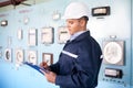 Young engineer taking notes at control room Royalty Free Stock Photo