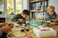 You dream it, I make it. Young engineer using soldering iron to join chips and wires. Robotics and software engineering Royalty Free Stock Photo