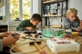 You dream it, I make it. Young engineer using soldering iron to join chips and wires. Robotics and software engineering Royalty Free Stock Photo