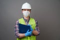 Young engineer worker wear a white helmet and medical mask