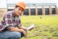 Young engineer working on site at the dam Royalty Free Stock Photo