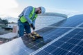 young engineer working using different tools, technician installing a solar panel using a rattle and drill Royalty Free Stock Photo