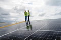 Young Engineers and Specialist Technicians Discuss and Check Quality of Installing Solar Photovoltaic Panels and Use App Royalty Free Stock Photo