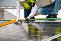 Young Engineers and Specialist Technicians Discuss and Check Quality of Installing Solar Photovoltaic Panels and Use App Royalty Free Stock Photo