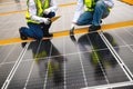 Young Engineers and Specialist Technicians Discuss and Check Quality of Installing Solar Photovoltaic Panels and Use App Royalty Free Stock Photo