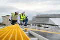 Young Engineers and Technicians Discuss and Check Quality of Installing Solar Photovoltaic Panels and Use App Technology Checking