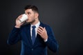 Young entrepreneur drinking refreshing hot espresso