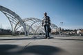 Young entrepreneur walks confidently in urban cityscape, ready for business discussions