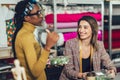 Young entrepreneur women, or fashion designers working in atelier and making short breakfast break at work Royalty Free Stock Photo