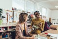 Young entrepreneur women, or fashion designers working in atelier and making short breakfast break at work Royalty Free Stock Photo