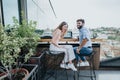 Young entrepreneurs execute their business expansion plan on a cloudy day over coffee in an urban cafe. Royalty Free Stock Photo