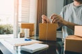 Young entrepreneurs are tie a rope cardboard boxes to pack the products for customers at home office Royalty Free Stock Photo