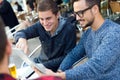 Young entrepreneurs working at coffee bar. Royalty Free Stock Photo