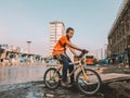 Young Ethiopian boy on a bicycle on the messy streets of Addis Ababa.