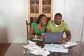 Young ethnic couple paying bills over internet