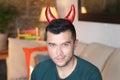 Young ethnic man with devil horns at home Royalty Free Stock Photo
