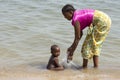 A young ethnic mother washing her baby.