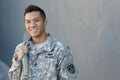 Young ethnically ambiguous American soldier holding backpack