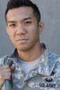 Young ethnically ambiguous American soldier holding backpack