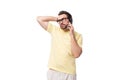 a young European brunette guy with a beard and mustache in glasses speaks on the phone Royalty Free Stock Photo