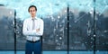 Young european businessman with creative image of cloud data icons on blurry background. Cloud computing, big data, technology and Royalty Free Stock Photo