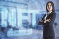 Young european businesswoman standing in blurry office interior with glowing NFT non fungible token concept hologram on blurry
