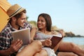 Young european couple resting on sandy beach Royalty Free Stock Photo