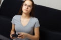 Young european dark-haired teen girl plays video games