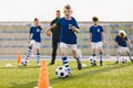 Young European Footballers Dribbling Balls. Happy Kids on Training Soccer Drill