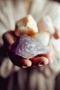 Young european girl holding a gemstone with boths hands in front of her.