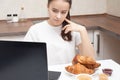 Young European girl reads the news on a laptop, upset, sad Royalty Free Stock Photo