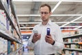 young european man buying shampoo in shopping mall Royalty Free Stock Photo