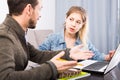 Tutor explaining material to his female client at home