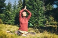 Young european woman doing yoga on the grass in autumn forest. Royalty Free Stock Photo