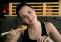 Young European woman eating sushi in an Asian restaurant Royalty Free Stock Photo