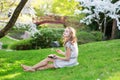 Young European woman eating sushi in Japanese park Royalty Free Stock Photo