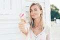 Young European woman holds melted strawberry ice cream in waffle cone Royalty Free Stock Photo