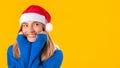 Young european woman in Santa hat looking at copy space and smiling, dreaming and waiting for winter holidays, panorama